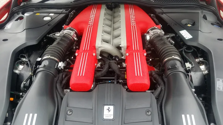Clean Ferrari V12 engine bay with red intake covers